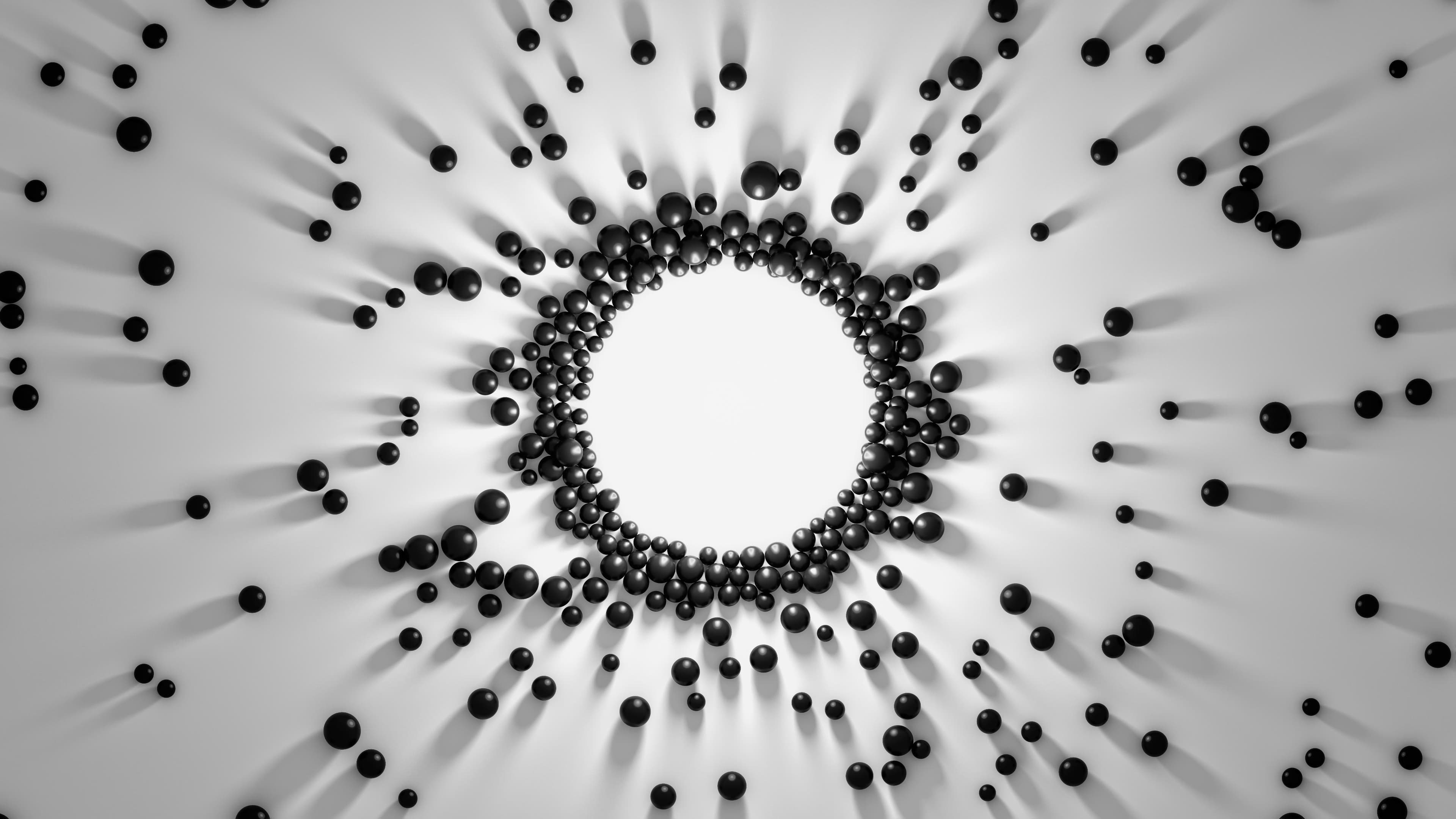 Black spheres clustered around a light