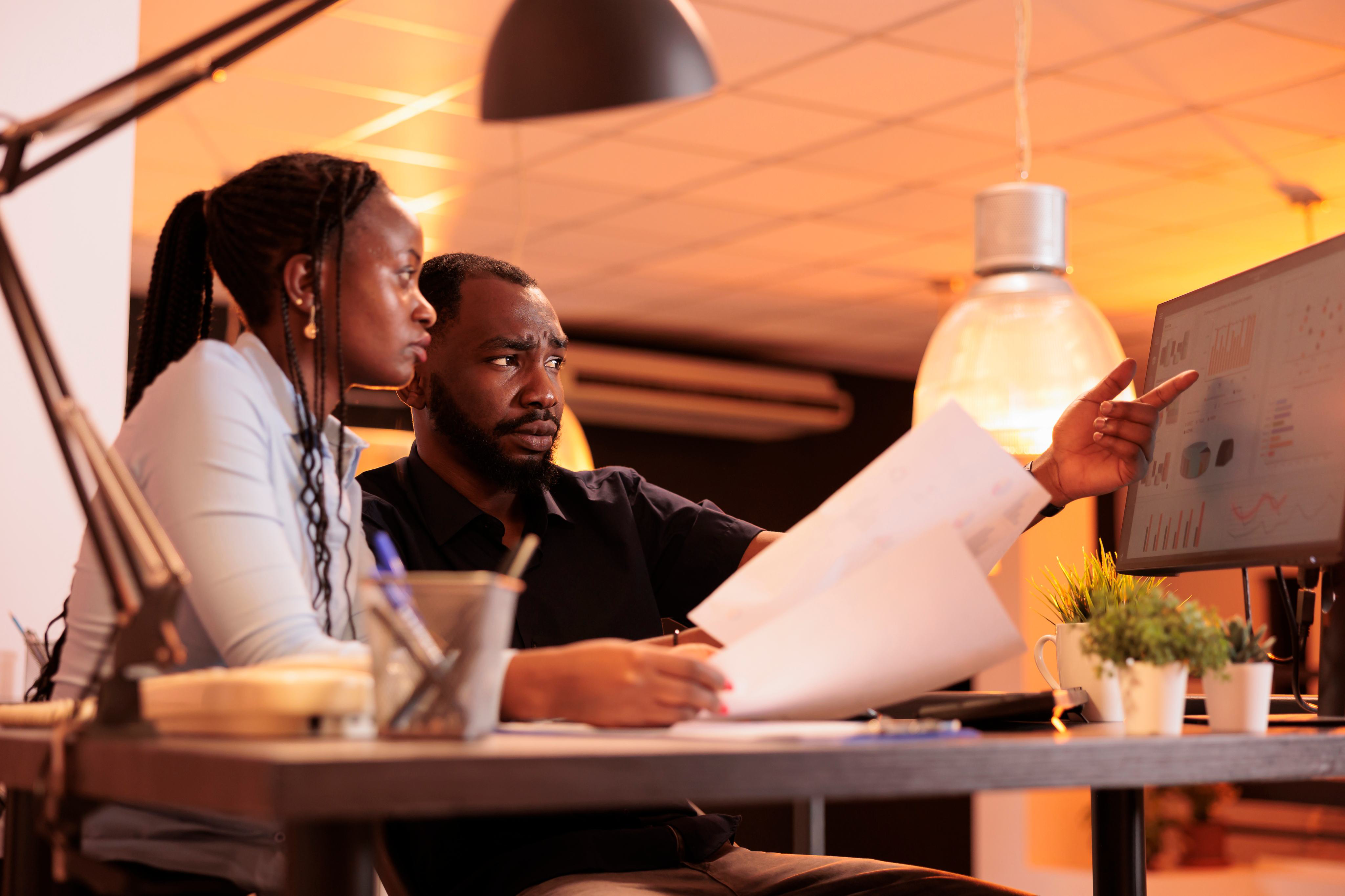 Two colleagues reviewing analytics together in an office